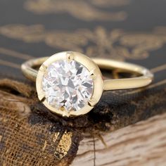 We took of our beautifully faceted old European cut diamond and set her in our Georgian-inspired collet setting (of course in yellow gold!). The result is a ring with a respectful nod to the past that is also appropriate to the diamond's age. A wonderful blend of the old and the new. Low set on the finger and just so incredibly charming! 18kt yellow gold Size 6, and fully sizable Diamond measures 7.31 - 7.49 x 4.63 mm GIA link here The "Fairfax" setting is also available to order for any one of our gemstones, or one of yours! Prices start at $2800. Timeless Diamond Ring With Bezel Setting, Timeless Classic Cut Diamond Ring With Single Cut Diamonds, Timeless Diamond Wedding Ring With Bezel Setting, Timeless Diamond Ring With Single Cut, Timeless Diamond Ring With Single Cut Diamonds, Heirloom Moissanite Diamond Ring With Bezel Setting, Heirloom 14k Gold Diamond Ring With Round Stone, Timeless Round Rose Cut Diamond Wedding Ring, Classic Rose Cut Diamond Wedding Jewelry With White Topaz