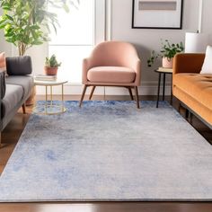 a living room filled with furniture and a rug