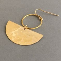 Hammered 14k gold fill half discs hang from circle hoops and earwires. Earrings from top of earwire measure 1.75 inches long and 1.25 inches wide. Also available in a sterling silver option with sterling silver earwires. Comes packaged in a small jewelry box. Gold Hammered Crescent Earrings, Gold Crescent Hammered Earrings, Gold Semi-circle Brass Jewelry, Gold Hammered Crescent Hoop Earrings, Gold Crescent Hoop Earrings With Hammered Detail, Yellow Gold Circle Brass Earrings, Yellow Gold Circle Earrings In Brass, Gold-tone Brass Hoop Earrings With Ear Wire, Gold-tone Hoop Earrings With Brass Ear Wire