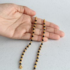 Handmade Black Temple Jewelry, Traditional Gold Beads With Black Details, Spiritual Black Jewelry For Puja, Traditional Black And Gold Beads, Black Round Beads Necklaces For Puja, Traditional Gold Bracelet With Black Beads, Black Bracelets For Festivals, Black Round Beaded Necklaces For Puja, Traditional Gold Beaded Bracelet With Black Beads