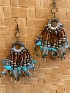 Dangling earrings, hung on a metal ring. Various turquoise, silver metal, copper tubular beads. Recovered materials from antique jewelry. Earrings Metal, Dangling Earrings, Metal Ring, Metal Rings, Gift Registry, Antique Jewelry, Jewelry Earrings Dangle, Metallic Silver, Coco