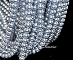 the beads are arranged together in this close up photo, and it looks like they have been made out of pearls