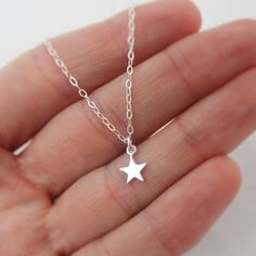 ALL STERLING SILVER - A GREAT KEEPSAKE This celestial necklace is lovingly hand-made with all solid sterling silver parts, making it a thoughtful gift (even for yourself!). A tiny shiny star dangles elegantly from the sparkly chain. Closes with an easy-to-use spring clasp. Star charm measures approximately 1/4 inch tall. Comes in a gift box, perfect for gift-giving. **SIZING - PLEASE READ: Select your necklace size at checkout. Note that necklaces will fit differently depending on a person's siz Silver Star-shaped Dainty Jewelry, Handmade Silver Charm Necklace For Birthday Gift, Silver Celestial Charm Necklace With Star Charm, Silver Star Charm Necklaces In Celestial Style, Silver Star Charm Necklace In Celestial Style, Silver Star-shaped Celestial Charm Necklaces, Handmade Star Shaped Sterling Silver Necklace, Sterling Silver Star Necklace In Silver, Personalized Star-shaped Sterling Silver Jewelry