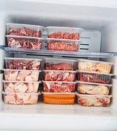 an open refrigerator filled with lots of meat and plastic containers full of food sitting on top of each other