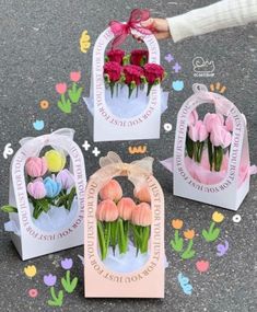 three bags with flowers in them on the ground