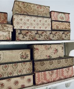 several old suitcases are stacked on top of each other in a storage area with white shelving