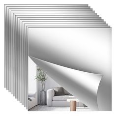 a room with white walls and lots of silver lines on the wall, along with a couch