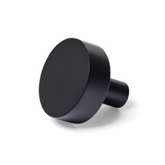 a black knob on a white background