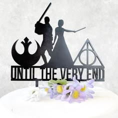 a cake topper that reads, until the very end with an image of a man and woman on it