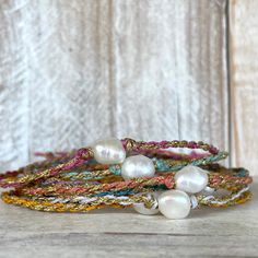 With a kiss of golden sun, this beautiful Beso del Oro bracelet is sure to add a touch of sparkle to your life! We weave one beautifully imperfect freshwater baroque pearl with gold and your choice of colorful waxed cord together to create this casual yet stylish piece. The closure is a simple tie on slide knot for easy on and off and is so soft and comfortable you'll forget you're wearing it and makes a great sparkly addition to any stacker ensemble! This bracelet/anklet is completely waterproo Gold Bracelets With Round Beads For Vacation, Gold Spiritual Friendship Bracelets For Festivals, Gold Spiritual Friendship Bracelet For Festivals, Handmade Gold Braided Bracelet For Vacation, Adjustable Gold Pearl Bracelet For Summer, Gold Sliding Knot Jewelry For Vacation, Gold Bracelet With Sliding Knot For Vacation, Gold Anklets With Round Beads For Beach, Bohemian Pearl Bracelet For Summer