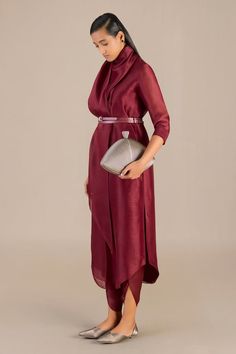 Maroon three fourth sleeves solid tunic with a curvilinear hem. Paired with a matching petal hem dhoti pant and a co-ordinating belt. - Aza Fashions Long Sleeve Kurta For Evening And Eid, Elegant Silk Long Sleeve Tunic, Elegant Long Sleeve Silk Tunic, Elegant Long Sleeve Silk Kurta, Elegant Fitted Tunic Kurta, Elegant Long Sleeve Tunic For Party, Elegant Silk Kurta For Work, Elegant Silk Kurta For Evening, Elegant Kurta For Eid Workwear