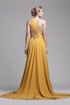 a woman in a yellow dress with an open back