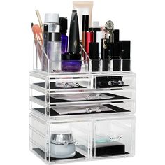 an acrylic makeup organizer is shown with all the items in its storage compartment