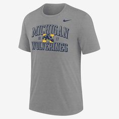 This Michigan T-shirt delivers comfort while boasting your school loyalty. A soft blend of fabric will make this your next go-to layer as you cheer on the Wolverines. Nike College Fan Apparel T-shirt, Collegiate Nike T-shirt With Team Name, Nike Collegiate T-shirt With Team Name, Nike Crew Neck T-shirt For College, Nike Collegiate T-shirt For Sports Season, Nike Collegiate T-shirt For Sports, Nike Cotton T-shirt In Athletic Heather, Gray Fan Gear T-shirt With Logo Print, Gray Cotton T-shirt With Team Logo