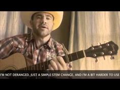 a man wearing a cowboy hat playing an acoustic guitar