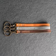 a pair of scissors with the words believe in yourself engraved on them sitting on a gray surface