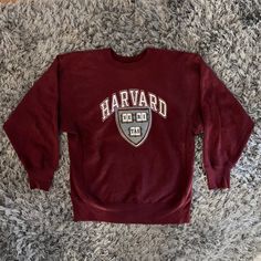 "Vintage Champion Harvard University Sweatshirt Size Large. Champion Tag. Maroon sweatshirt with front print. Front Print: \"Harvard\" with image of school crest. Some staining (shown in photos) THIS ITEM IS A VINTAGE / PRE-WORN PIECE SO SOME SIGNS OF NATURAL WEAR AND AGE ARE TO BE EXPECTED. 1150" Harvard Merch, School Crest, Harvard Sweatshirt, Maroon Sweatshirt, Blank Sweatshirts, University Sweatshirts, College Sweatshirt, Champion Reverse Weave, Harvard University