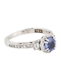 a white gold ring with an oval blue sapphire and diamonds