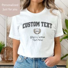 Celebrate school pride with this custom college t-shirt. An Ivy League aesthetic features personalized college font and script font along with a customizable date. Perfect college apparel for matching team shirts, graduation gifts, college admissions and in support of your favorite college or student.  MATCHING Custom Sweatshirt: https://deesinspire.etsy.com/listing/1644438694 Send a message to Denise with any questions. ~T-Shirt~ ✦ 100% Airlume combed and ring-spun cotton, (4.2 oz/yd² (142 g/m making it lightweight and soft (see below for color variation fabric blends) ✦ Bella+Canvas manufactures all its products in the US and internationally in humane, no-sweat-shop, sustainable way and is part of the Fair Labor Association as well as Platinum WRAP certified. ✦ Tear away product tag for College Style Crew Neck T-shirt For College Events, Collegiate Short Sleeve T-shirt For Campus, Customizable Crew Neck School T-shirt, Varsity Graphic Print T-shirt For Campus, Collegiate Letter Print T-shirt For Campus, White Crew Neck T-shirt For College Events, Customizable Team Spirit Crew Neck T-shirt, Customizable Varsity Tops For Streetwear, White Varsity T-shirt For School