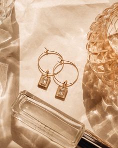 The Madame Earrings are simple and elegant at the same time. Inspired by the Hall of Mirrors at Versailles, these glistening beauties will add a touch of luxe to your look. Charms are 14K gold plated with Cubic Zirconium. 8x11.3mm. Hoops are 14K gold filled, 15x2mm. Madame Earrings Jewelry Mood Board, Creative Jewelry Photography, Jewelry Styling, Color Aesthetic, Hall Of Mirrors, Earrings Square, Turquoise Stud Earrings, Jewelry Photoshoot, Working Women