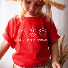 Your toddler will look adorable in this cute tshirt that features strawberries and the words Be a Sweet Human. This super soft tee is perfect for infants and toddlers sensitive skin. Make a great gift for a strawberry lover. * Q U I C K * F A C T S * ♥ 100% cotton ♥ Design is high quality digital print ♥ Wash and dry normally (on cool for best results) * S I Z I N G * ♥ 2T: 30-33 lb / 32-35'' ♥ 3T: 33-36 lb / 35-38'' ♥ 4T: 36-40 lb / 38-40'' ♥ 5T: 40-45 lb / 40-43'' ♥ Please see size guide in li Cute Pink T-shirt With Strawberry Print, Fun Strawberry Print Crew Neck T-shirt, Playful Red T-shirt For Summer, Sweet Short Sleeve Tops With Fruit Print, Sweet Cotton Tops With Fruit Print, Sweet Red Summer Tops, Red Crew Neck T-shirt, Sweet Strawberry Print Short Sleeve T-shirt, Cute Strawberry Print Crew Neck T-shirt