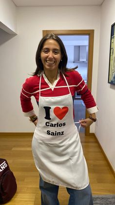 a woman wearing an apron and smiling at the camera