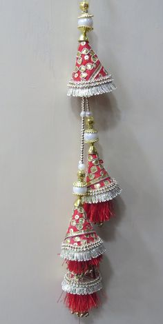 Red And Golden Fabric Gota Patti and Pearl Beaded Traditional Indian Bridal Lehenga Tassels | Ethnic Sewing Tassel Latkan For Indian Saree Handmade Hanging/tassels Material:Silk, Thread, Motifs, Gota Patti Package Contents: 4 Key Features: Embroidery art work This is good match with both Indian Bridal Lehenga outfits and are superb for wedding and festive parties. This would be best complement to your designer saree, lenhga or any other kind of dress. This is the combination of traditional and m Luxury Red Jhumkas With Latkans, Luxury Traditional Danglers With Latkans, Multicolor Anarkali Dupatta With Tassels, Multicolor Tassel Sets For Diwali, Red Choli With Motifs For Navratri, Festive Sharara With Tassels And Traditional Drape, Festive Traditional Drape Sharara With Tassels, Multicolor Traditional Wear With Tassels, Bollywood Style Multicolor Tassel Sets