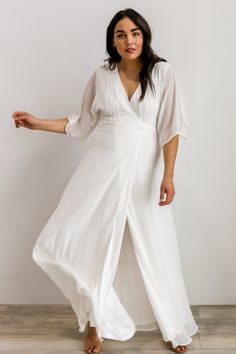 Beautiful flowing chiffon material True wrap style maxi dress Fully lined except sleeves Darted bust detail for a tailored fit Kimono style sleeve 100% Polyester Becca is 5'10", size 10/12, and wearing size L Airy Flowy V-neck Dress, Chiffon Wedding Dress With Surplice Neckline, White Flowy V-neck Wrap Dress, Elegant White Chiffon V-neck Dress, Elegant White V-neck Chiffon Dress, White Chiffon Maxi Dress For Evening, White Chiffon Evening Maxi Dress, White Flowy V-neck Maxi Dress, Elegant Flowy Chiffon Dress With Surplice Neckline