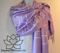 a purple and white scarf on a mannequin's head with the words inspired with love written across it