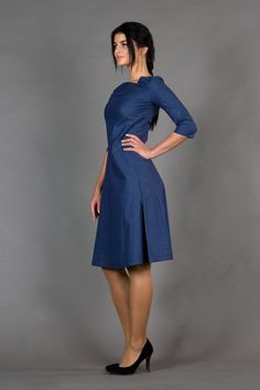 "An asymmetrical dress featuring fit and flare silhouette, midi length, and 3/4 sleeves. - asymmetrical v-neck - 3/4 sleeves - flared skirt with inverted front pleat - fit and flare silhouette - midi length - extraordinary dart in the front - concealed back zipper closure Color: dark blue Fabric: cotton - 95%, elastane - 5% For Size S (6 US): dress length - 40\" (101 cm), sleeve length - 15,3\" (39 cm) Our model wears size S (06) and is 171 cm/5'6\" tall Model in the photo: 64,5\" (164 cm) heigh Summer A-line Midi Dress With Flattering Cut, Spring Midi-length V-neck Dress With Flattering Silhouette, Solid Color Office Dress With 3/4 Sleeve, Modern Asymmetrical Dress For Spring Formal, Fitted Knee-length Bridesmaid Dress, Elegant Fitted A-line Asymmetrical Dress, Elegant Fitted Asymmetrical A-line Dress, Spring Flattering Cut Knee-length Midi Dress, Spring Knee-length Midi Dress With Flattering Cut