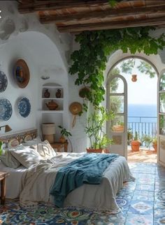 a bedroom with an arched doorway leading to the ocean and greenery on the walls