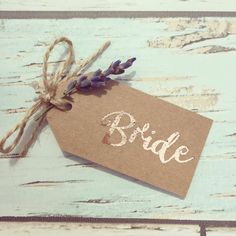 a piece of paper with the word bride written on it next to some lavender flowers