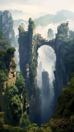 an arch in the middle of a mountain with trees on both sides and fog hanging from it