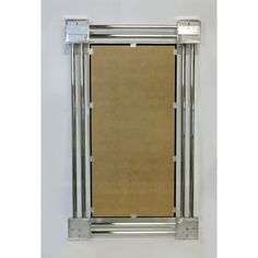 a metal frame with a brown sheet hanging from it's side on a white wall