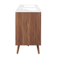 a wooden cabinet with a white sink on it's top and two legs in front