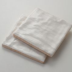 two white napkins sitting on top of each other