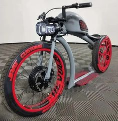 an electric scooter with red rims on the front wheel and black tires