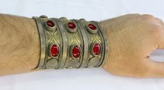 "Vintage Turkmen Traditional Ethnic Tribal Partial Gold Gilded Glass Beads Large Bracelet. Please do not hesitate to contact if you have any questions. Weight : 160.0 grams Inner circumference : 14.5 cm ( 5.7\" ) Width : 8.4cm ( 3.3\" ) Please know what you are bidding on. The metal of Most Kuchi, Afghan and Turkoman items are called with different names but they all work in same metal, Some called Alpaca silver, German Silver and Tibetan Silver. They do not give any allergies or body reaction . Handmade Medieval Cuff Bracelet As Gift, Medieval Handmade Cuff Bracelet As A Gift, Handmade Medieval Cuff Bracelet For Gifting, Traditional Cuff Bangle For Festival, Traditional Festival Cuff Bangle, Bohemian Metal Cuff Bracelet For Ceremonial Occasions, Red Metal Bohemian Bangle, Red Bohemian Metal Bangle, Bohemian Red Metal Bangle