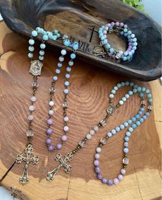 Rosaries handcrafted with high quality gemstones and accented with solid bronze crucifix and beautifully detailed OLO Lourdes medal. Available in two color schemes: blue & white and blue, white & purple. Handmade Adjustable Crucifix Jewelry, Handmade Crucifix Jewelry For Jewelry Making, Adjustable Cross Jewelry With Natural Stones, Handmade Crucifix For Jewelry Making, Adjustable Cross-shaped Jewelry With Natural Stones, Spiritual Crucifix Jewelry With 8mm Beads, Spiritual Rosary Bracelet With Natural Stones For Healing, Spiritual Crucifix Gemstone Jewelry, Spiritual Beaded Cross Pendant Jewelry