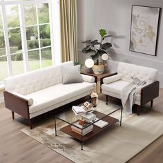 a living room with two couches and a coffee table in front of a large window