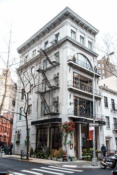 a tall white building sitting on the side of a street