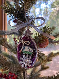 a christmas ornament hanging from a tree