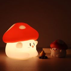 a mushroom shaped lamp next to a small toy