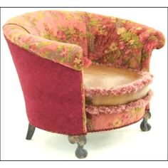 a chair that is sitting on wheels with a flowered upholstered back and arms