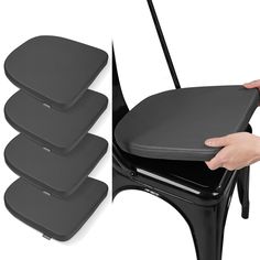 four black chairs with one person holding the seat up and another hand reaching for it