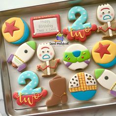 decorated cookies in the shape of numbers on a cookie sheet for two year old birthday