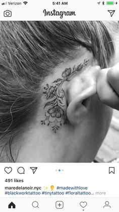 a woman's behind the ear has a flower tattoo on her left side ribcage