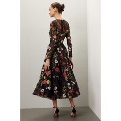 Black floral jacquard (54% Silk 46% Polyester). Full skirt. Long sleeves. Crewneck. Back zipper closure. 48" from shoulder to hemline. Made in the Usa. Knee-length Floral Dress For Evening, Elegant A-line Floral Dress For Fall, Floral Print A-line Midi Dress For Gala, Spring Gala Floral Print Midi Dress, Evening Floral Knee-length Dress, Floral Print A-line Midi Dress For Evening, Chic Formal Midi Dress With Floral Embroidery, Evening A-line Midi Dress With Floral Print, Elegant Midi Floral Dress For Formal Occasions