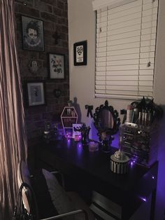 a desk with various items on it in front of a brick wall and purple light