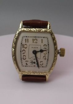 This beautiful Elgin watch looks just like it did when it came home from a Jewelry store in 1928.  The watch is simply amazing. This is an Elgin, 15 Jewel, Art Deco Style Wristwatch, circa. 1928.  This watch has an Elgin 3/0s size, circa. 1928, Grade 464, model 2, 15 Jewel movement.  This is one of the finest wristwatch size movements Elgin made at that time and has a very precise screw adjustment regulator for very fine regulating of the balance spring.   The watch has a perfect white linen col Classic Watches With Rectangular Dial For Collectors, Classic Collectible Watch With Rectangular Dial, Antique Formal Watches With Subdials, Vintage Yellow Gold Watch With Rectangular Dial, Vintage Rectangular Chronometer Watch, Art Deco Rectangular Quartz Watch, Antique Yellow Gold Analog Watch, Antique Formal Analog Watch, Antique Analog Watch For Formal Occasions